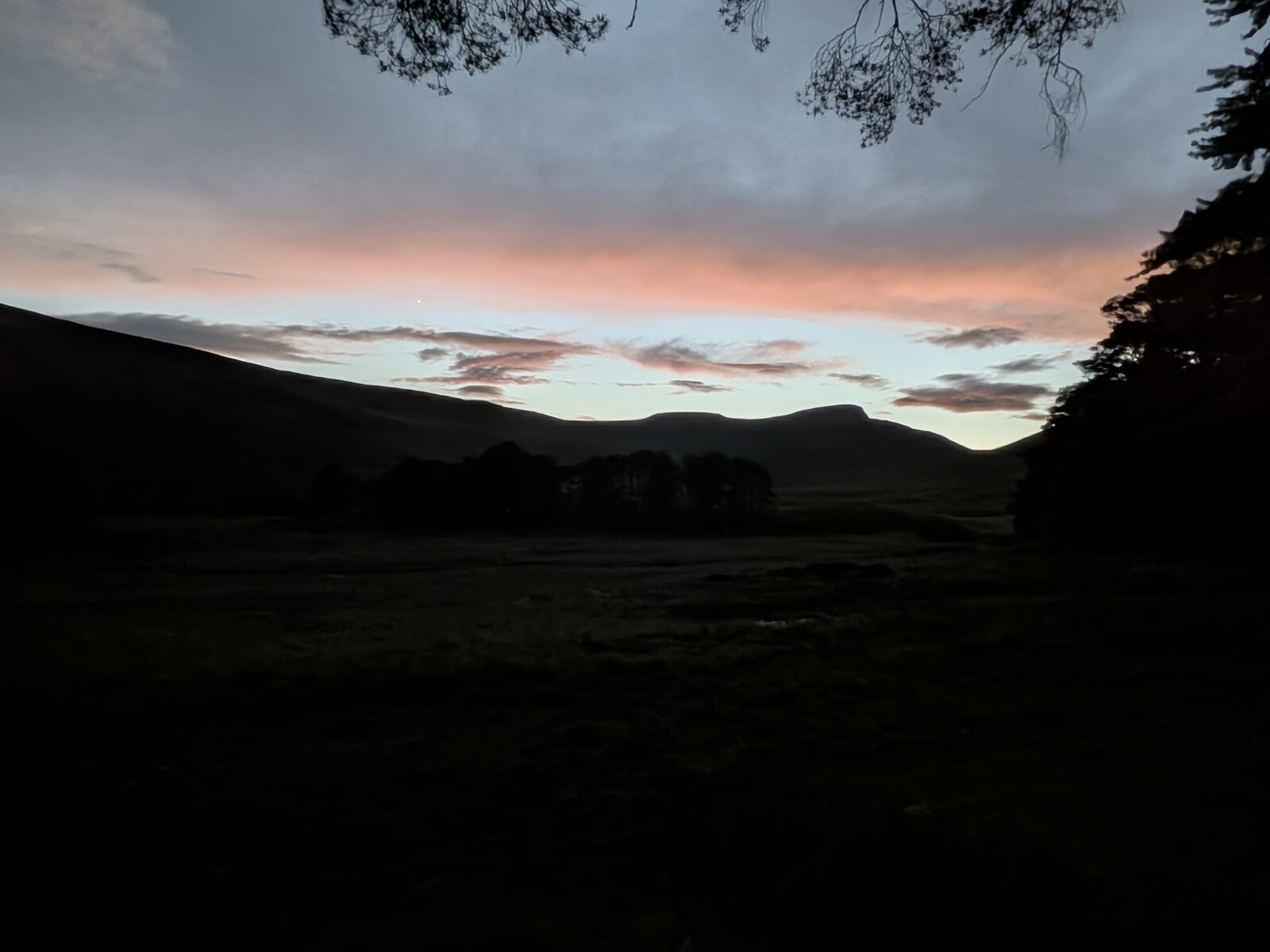 Sunset over silhouetted Welsh hills